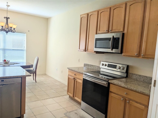 753 Largo Pass, Poinciana, FL 34759 - kitchen with an inviting chandelier, light tile patterned flooring, baseboards, appliances with stainless steel finishes, and decorative light fixtures
