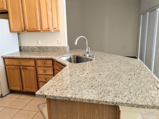 753 Largo Pass, Poinciana, FL 34759 - kitchen featuring a peninsula, light tile patterned flooring, light stone countertops, brown cabinets, and a sink