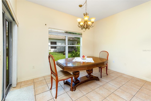 753 Largo Pass, Poinciana, FL 34759 - dining room featuring baseboards, a notable chandelier, and light tile patterned floors