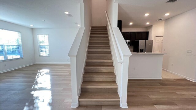 stairway featuring hardwood / wood-style flooring