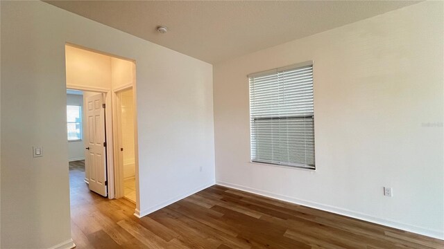 unfurnished room featuring hardwood / wood-style flooring