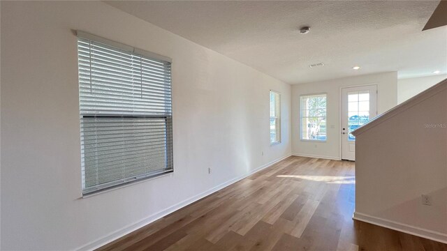 entrance foyer featuring a textured ceiling and hardwood / wood-style flooring