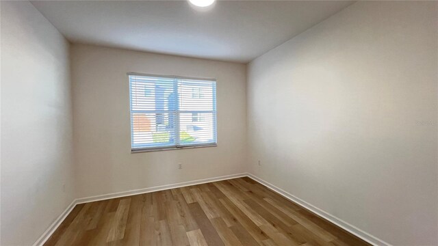 unfurnished room featuring hardwood / wood-style flooring