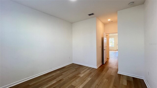 spare room with wood-type flooring