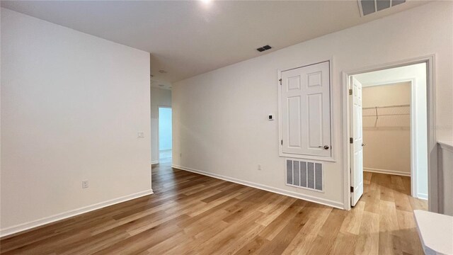 spare room with light hardwood / wood-style flooring