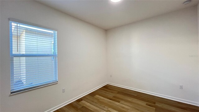 unfurnished room with hardwood / wood-style floors