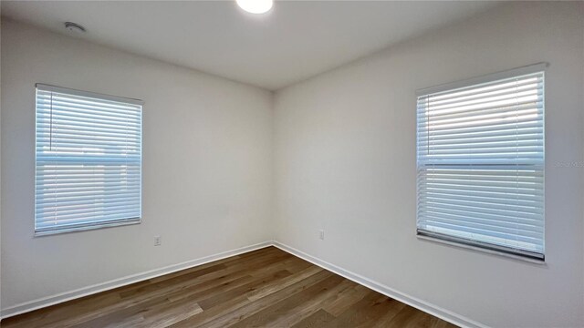 unfurnished room with wood-type flooring and a wealth of natural light