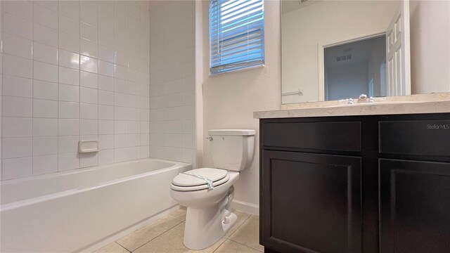 full bathroom with tile patterned flooring, vanity, toilet, and tiled shower / bath