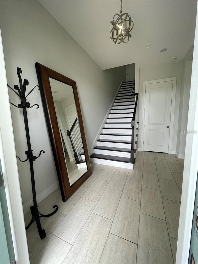 stairway with a chandelier and hardwood / wood-style flooring