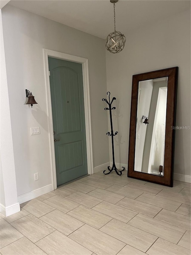 entrance foyer featuring an inviting chandelier