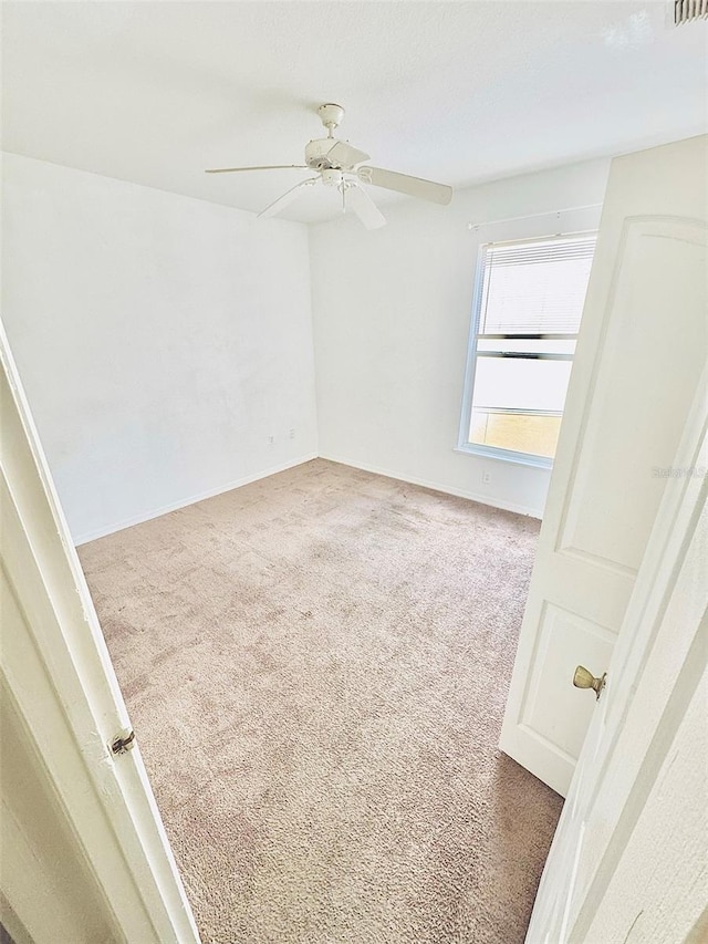 empty room with carpet and ceiling fan