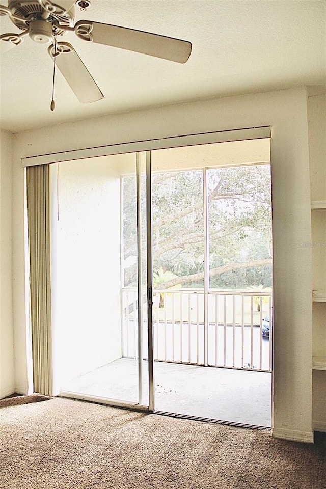 interior space featuring carpet flooring and ceiling fan