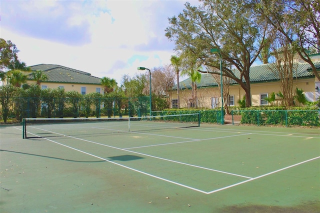 view of tennis court with fence