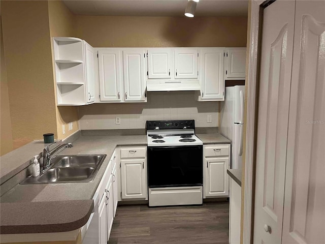 kitchen with freestanding refrigerator, a sink, electric range oven, white cabinets, and under cabinet range hood