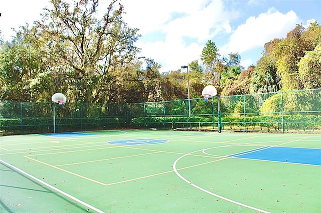 view of basketball court with community basketball court and fence