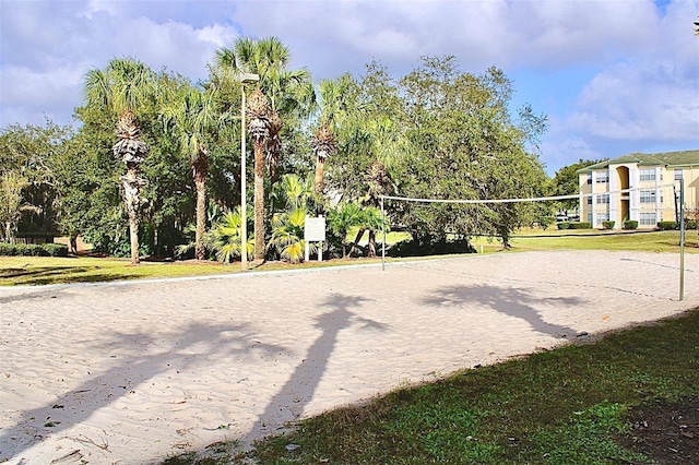 view of community featuring a lawn and volleyball court