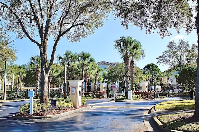 view of street featuring curbs and a gated entry