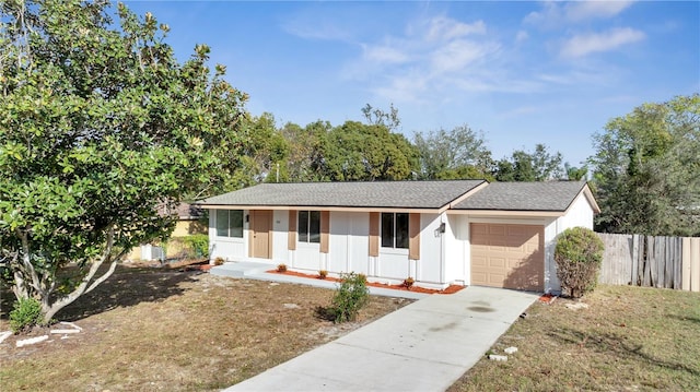 single story home featuring a front lawn, covered porch, and a garage