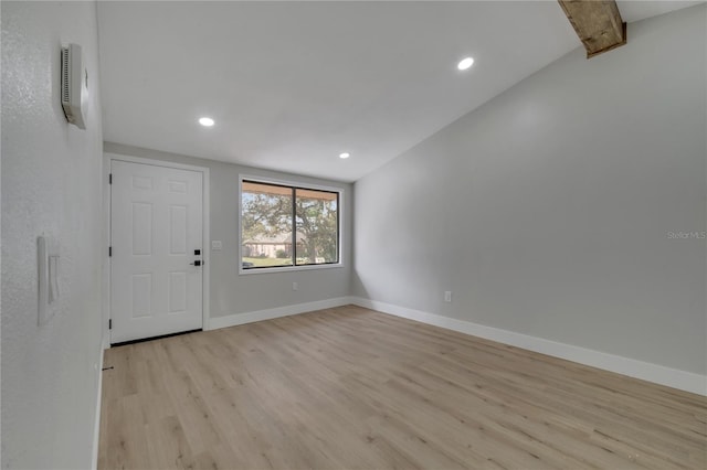 foyer with lofted ceiling and light hardwood / wood-style flooring