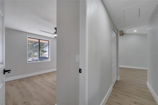 hallway with light hardwood / wood-style floors