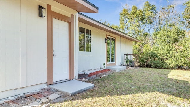 doorway to property featuring a yard