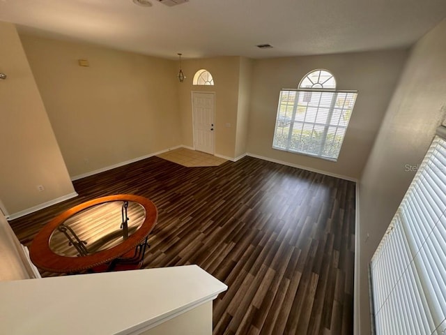 unfurnished living room with dark wood-type flooring