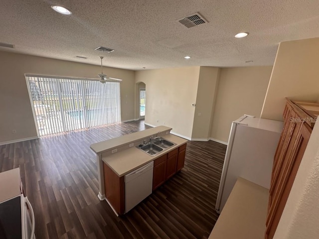 kitchen featuring dishwasher, a center island, sink, ceiling fan, and dark hardwood / wood-style flooring