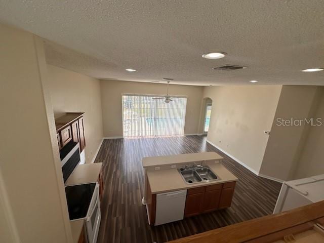 kitchen featuring a textured ceiling, sink, white dishwasher, and dark hardwood / wood-style floors