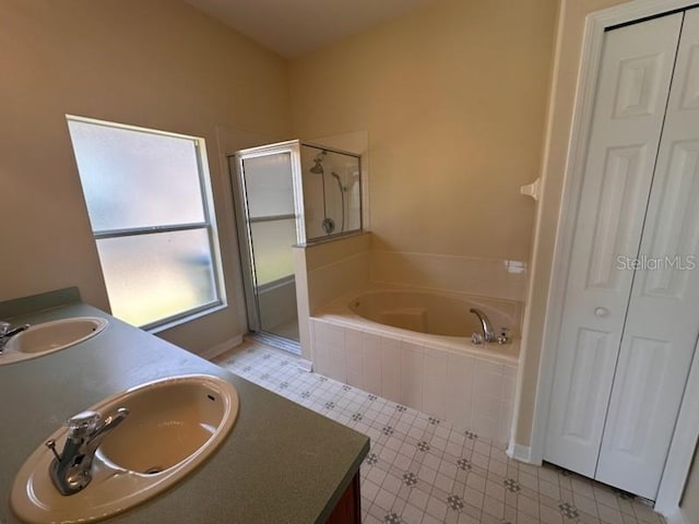 bathroom featuring shower with separate bathtub and vanity