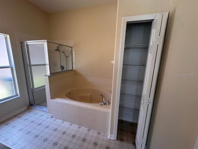 bathroom featuring tile patterned flooring and separate shower and tub