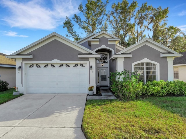 view of front of property with a garage and a front yard