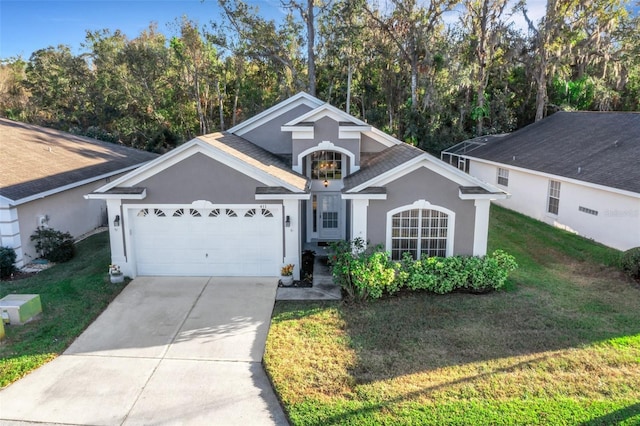 view of front of home with a front lawn and a garage