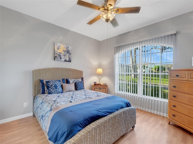 bedroom with light wood-type flooring and ceiling fan