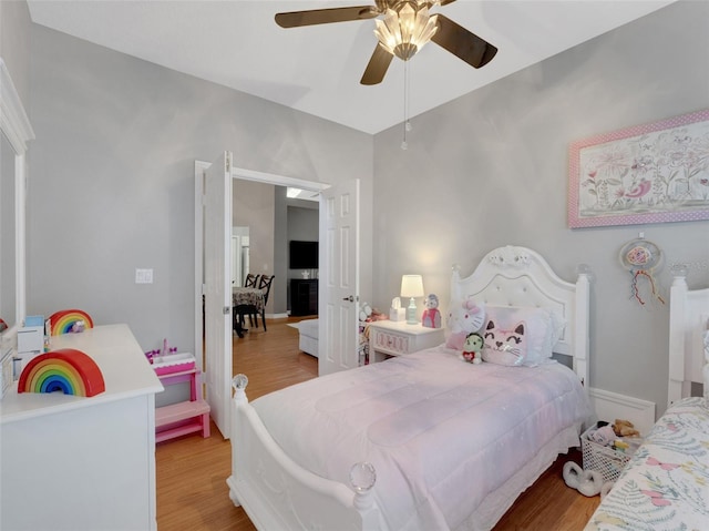 bedroom with light hardwood / wood-style flooring and ceiling fan