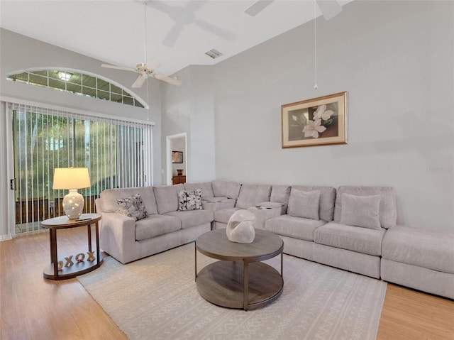 living room with hardwood / wood-style flooring and high vaulted ceiling