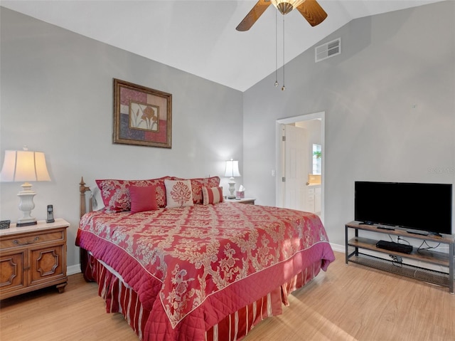 bedroom featuring hardwood / wood-style floors, ensuite bathroom, vaulted ceiling, and ceiling fan