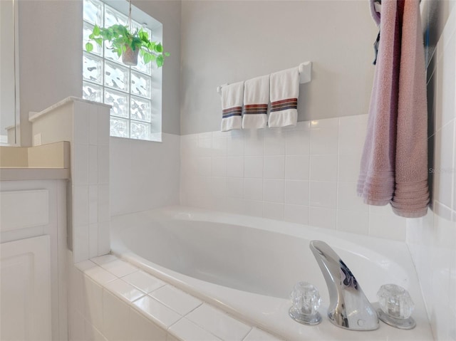 bathroom with tiled bath