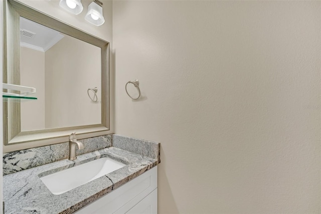 bathroom with crown molding and vanity