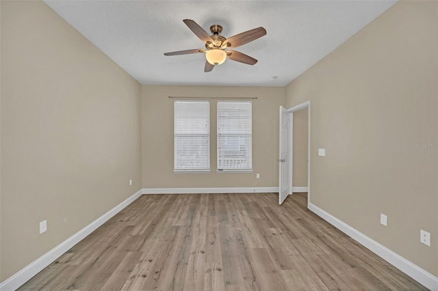 spare room with a textured ceiling, light wood-type flooring, and ceiling fan