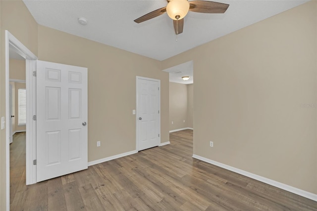 unfurnished bedroom featuring ceiling fan and light hardwood / wood-style floors