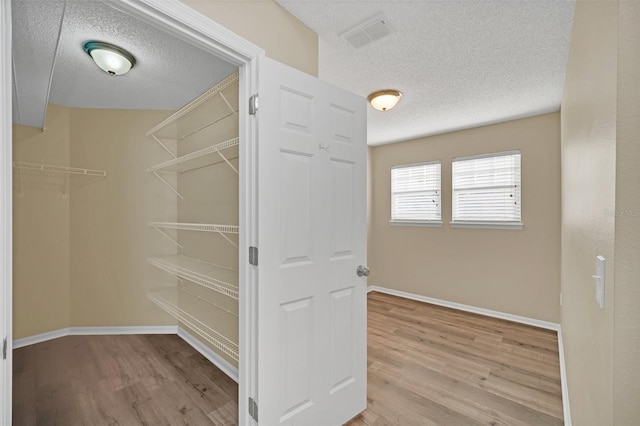 walk in closet featuring light hardwood / wood-style flooring