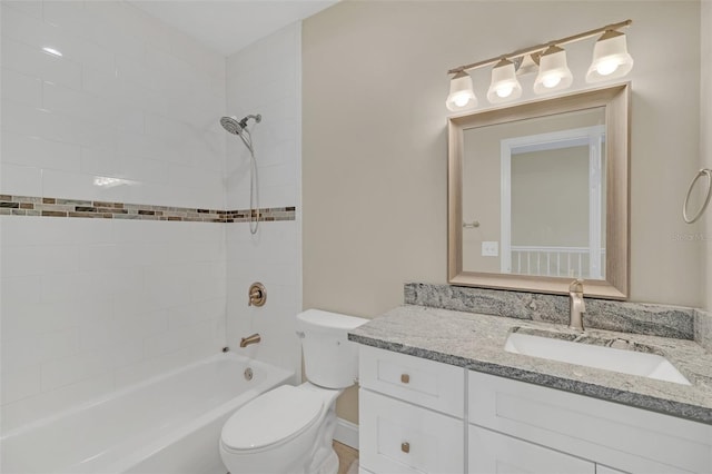 full bathroom featuring vanity, tiled shower / bath combo, and toilet