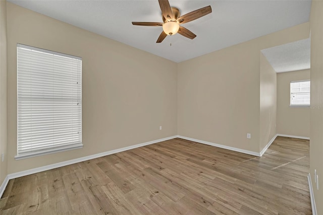 empty room featuring ceiling fan and light hardwood / wood-style flooring