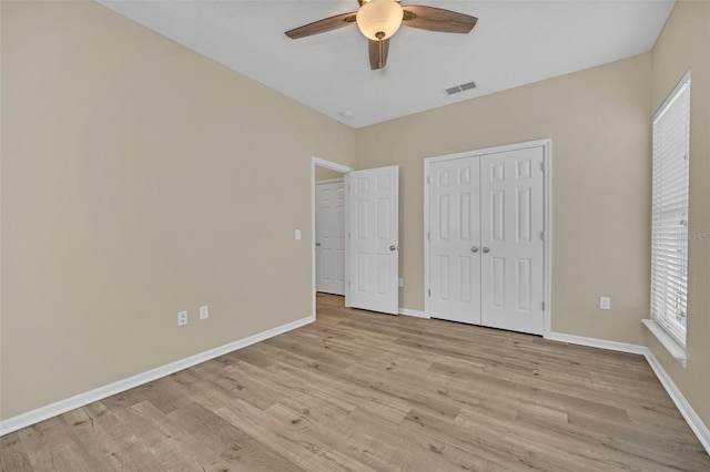 unfurnished bedroom featuring a closet, ceiling fan, and light hardwood / wood-style flooring