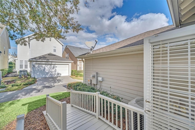 deck featuring a garage, central AC unit, and an outdoor structure