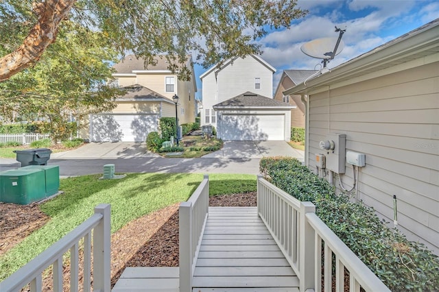 view of yard featuring a garage and an outbuilding