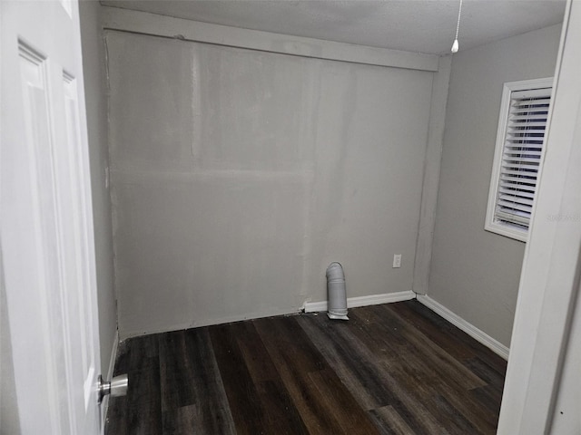 laundry area featuring a textured ceiling and dark hardwood / wood-style floors