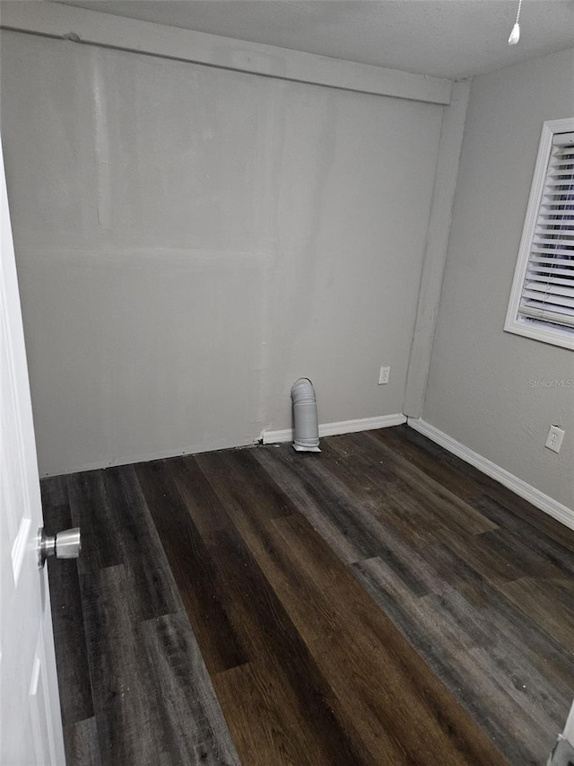 unfurnished room featuring dark hardwood / wood-style flooring