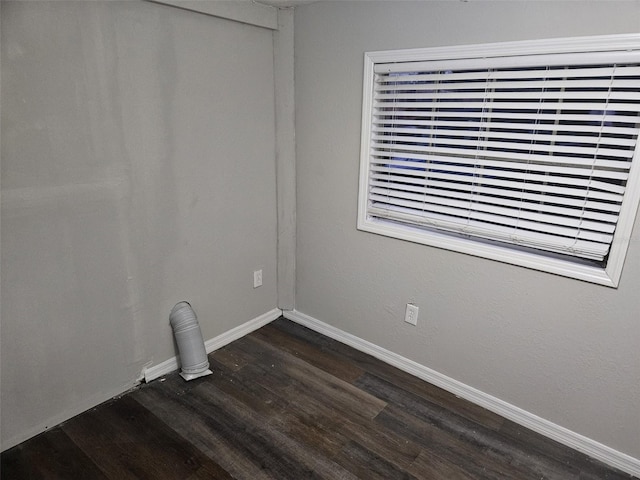 spare room featuring dark wood-type flooring