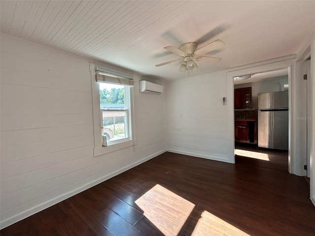 empty room with a wall mounted air conditioner, ceiling fan, dark wood-type flooring, and wooden walls